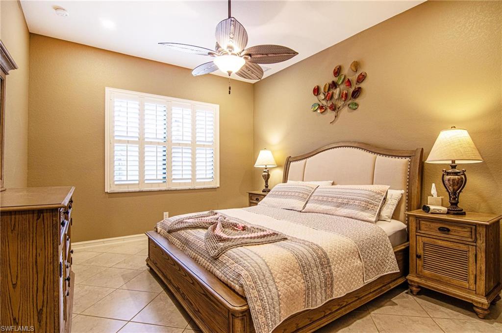 Bedroom featuring light tile patterned floors and a ceiling fan