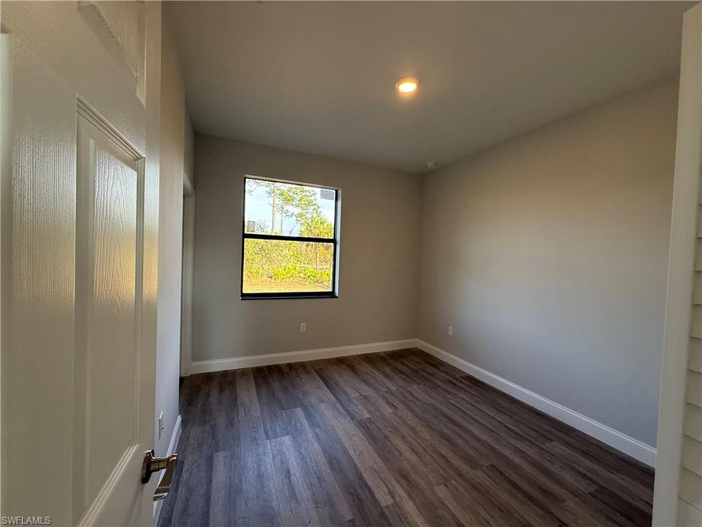 Spare room featuring dark wood finished floors and recessed lighting