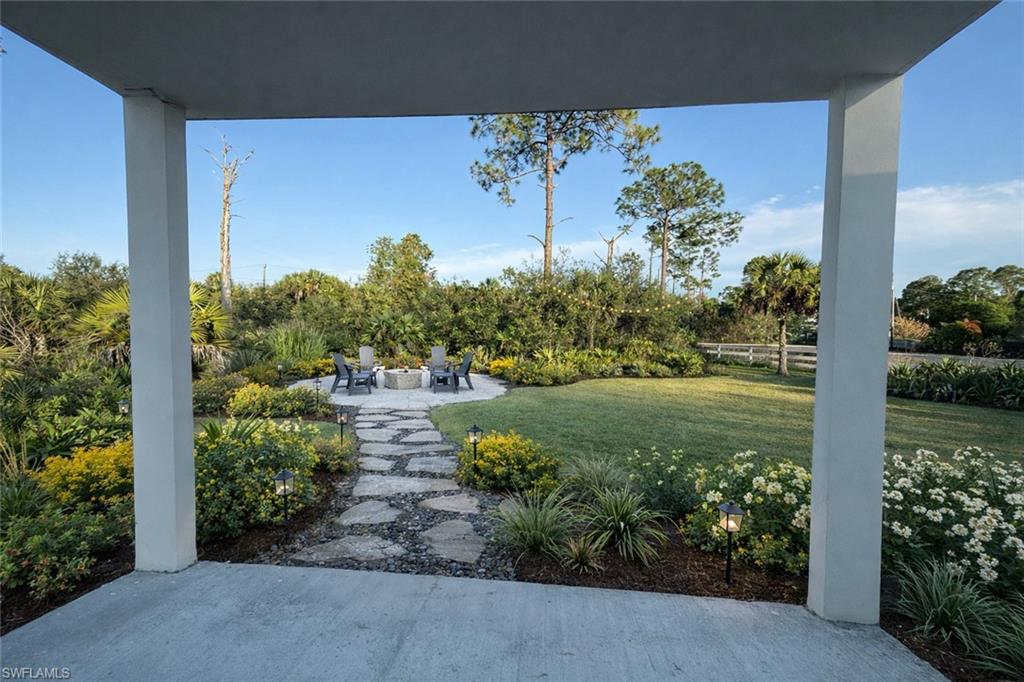 View of yard featuring a patio area and an outdoor fire pit