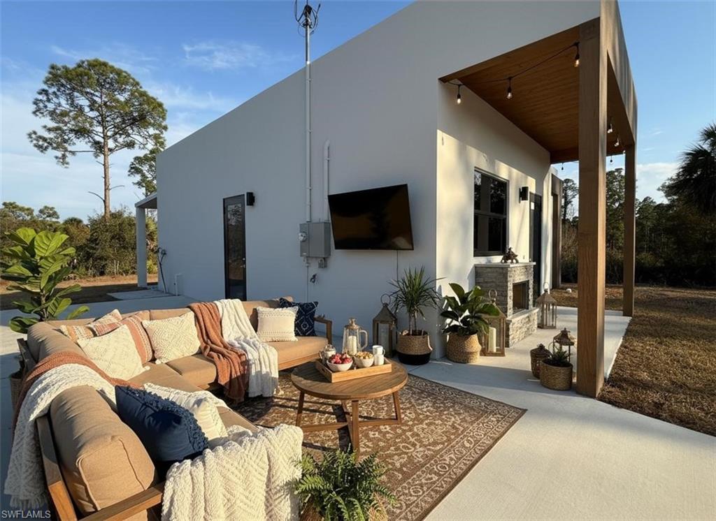 View of patio / terrace with an outdoor living space with a fireplace
