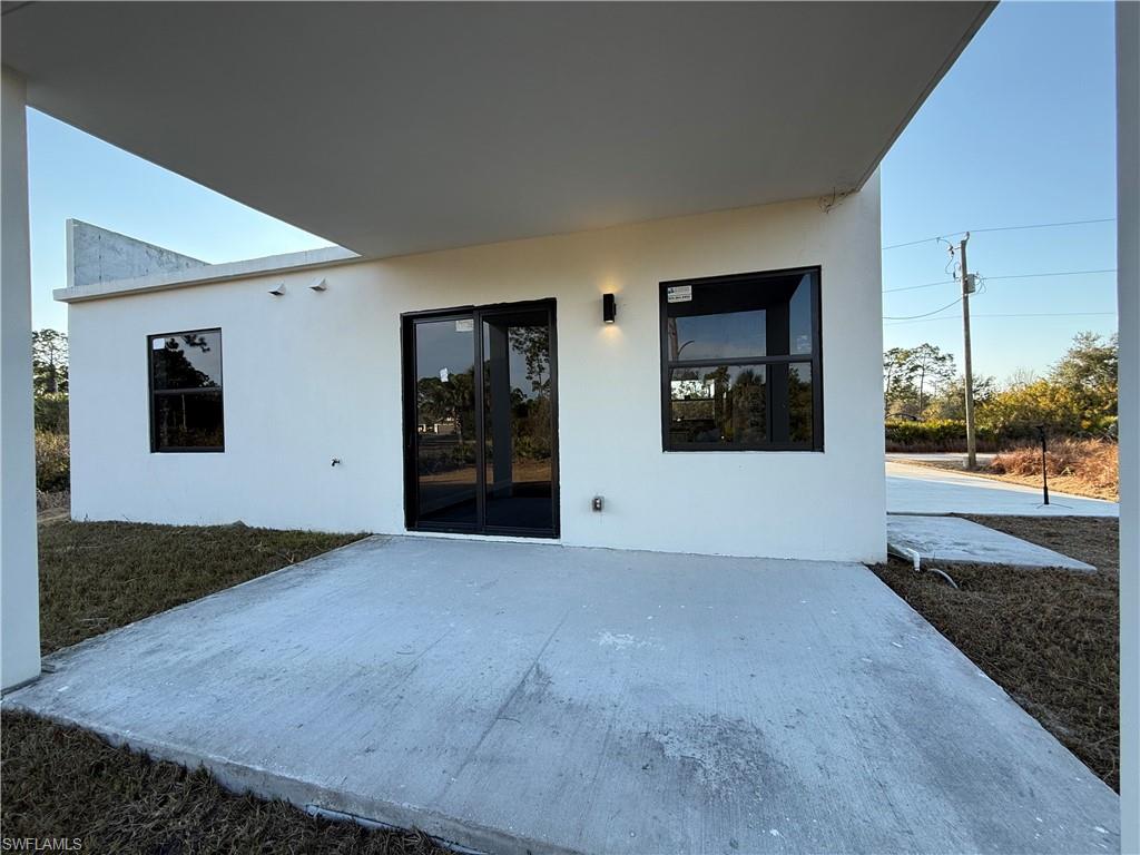 Back of property with a patio area and stucco siding