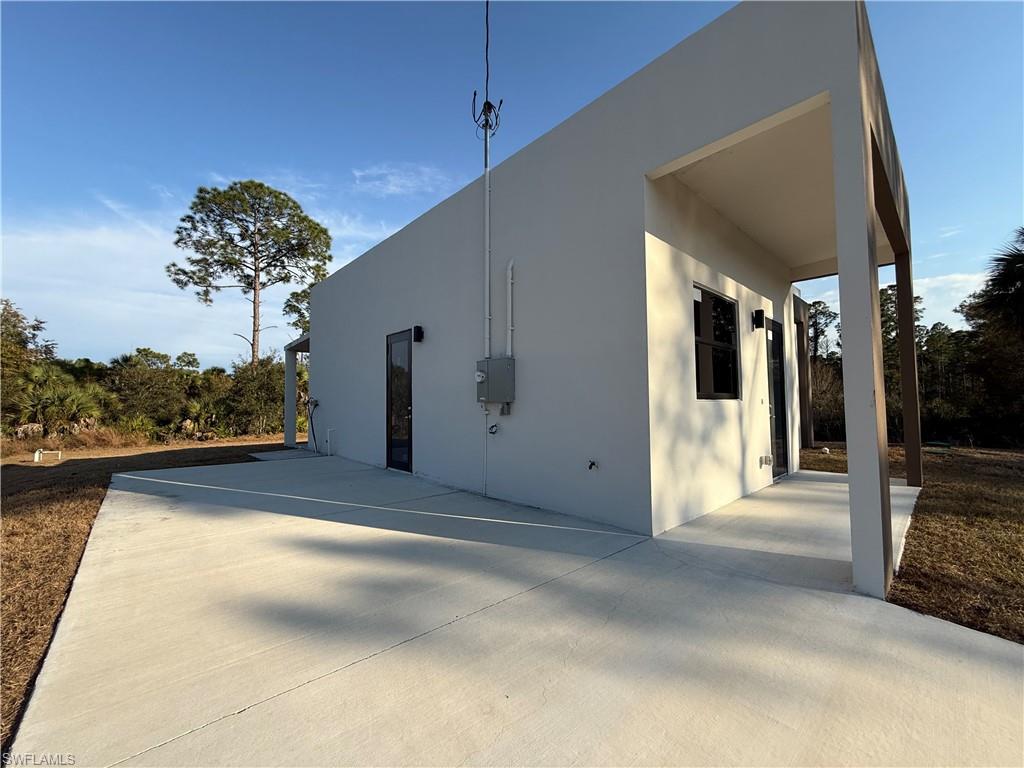 View of property exterior with stucco siding