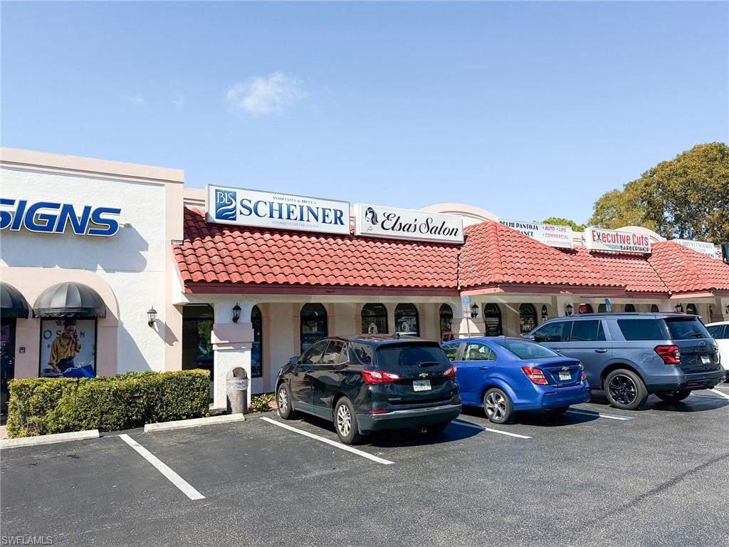 View of building exterior with uncovered parking