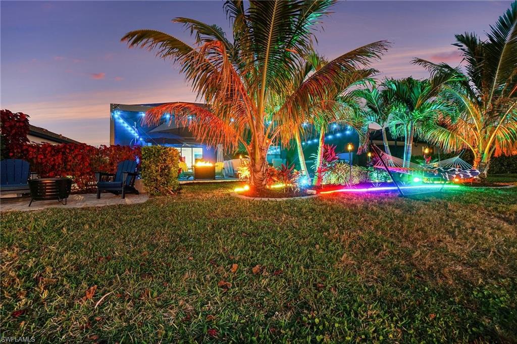 View of grassy yard with a patio area
