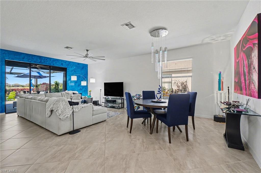 Dining area with ceiling fan and a textured ceiling