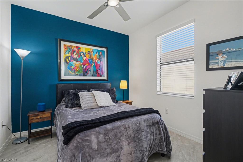 Bedroom with a ceiling fan and baseboards