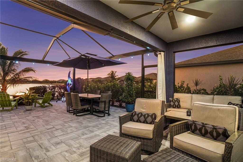 Patio terrace at dusk featuring outdoor lounge area, a lanai, a patio area, and a sunroom