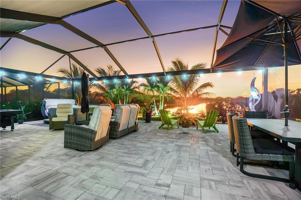 View of patio with a sunroom, glass enclosure, and outdoor dining space