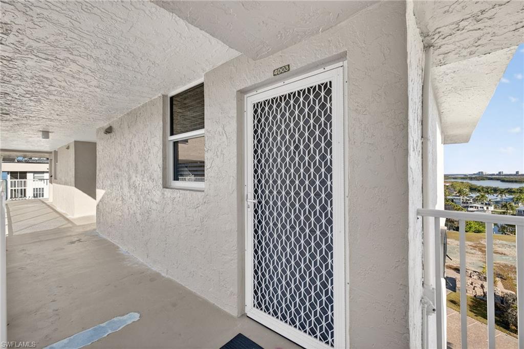 Doorway to property featuring stucco siding