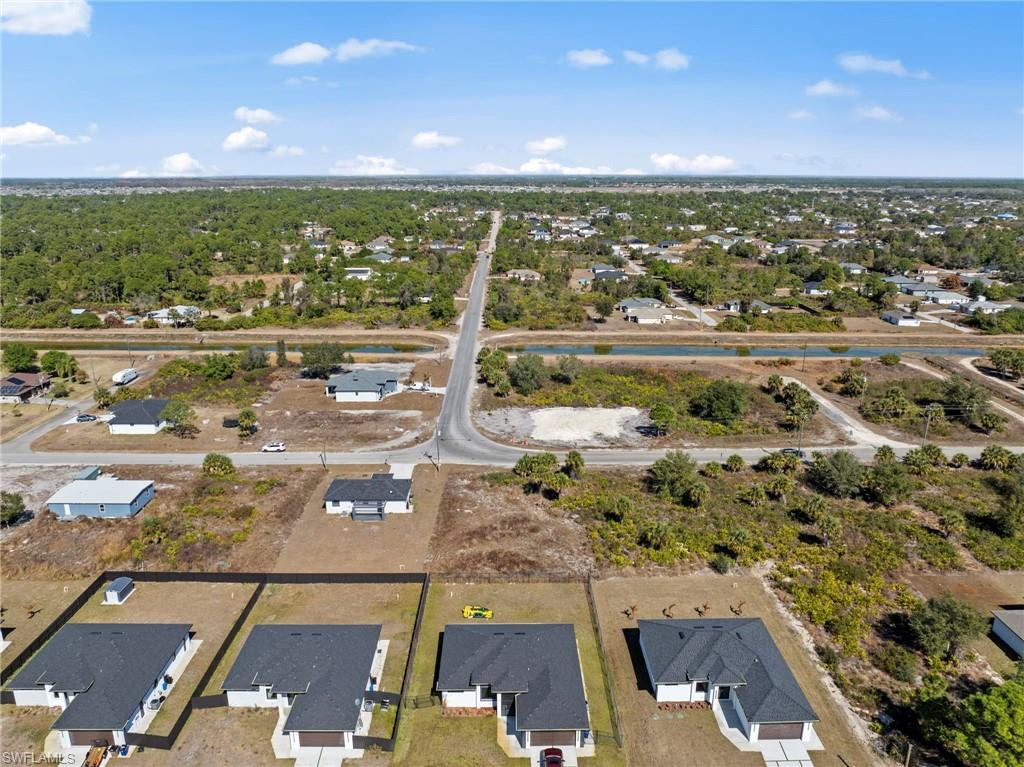 Aerial view of property's location with nearby suburban area