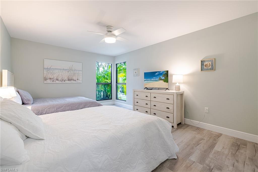 Bedroom with light wood-style floors and a ceiling fan