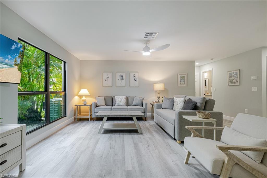 Living room with a ceiling fan and wood finished floors