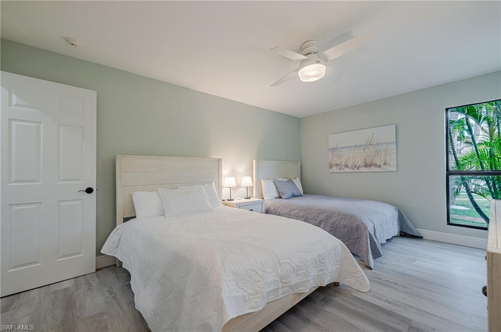 Bedroom with light wood-type flooring and a ceiling fan