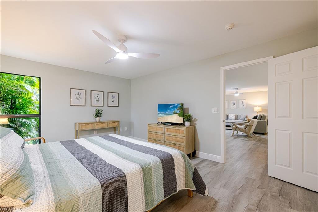 Primary Bedroom with light wood-style flooring and ceiling fan