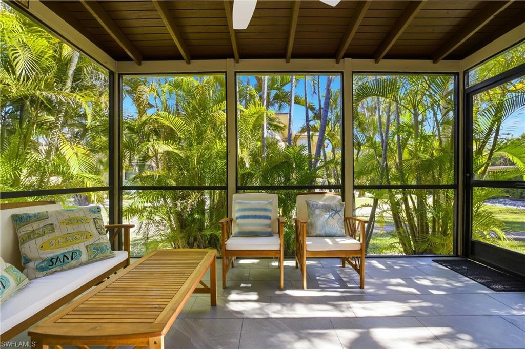 Sunroom with floor to ceiling windows and a wood ceiling with exposed beams