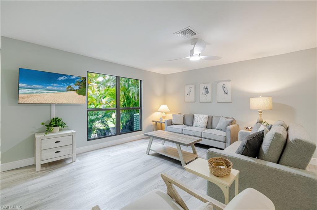 Living room featuring ceiling fan and light wood-style floors