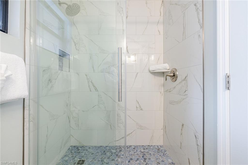 Bathroom with a marble finish shower