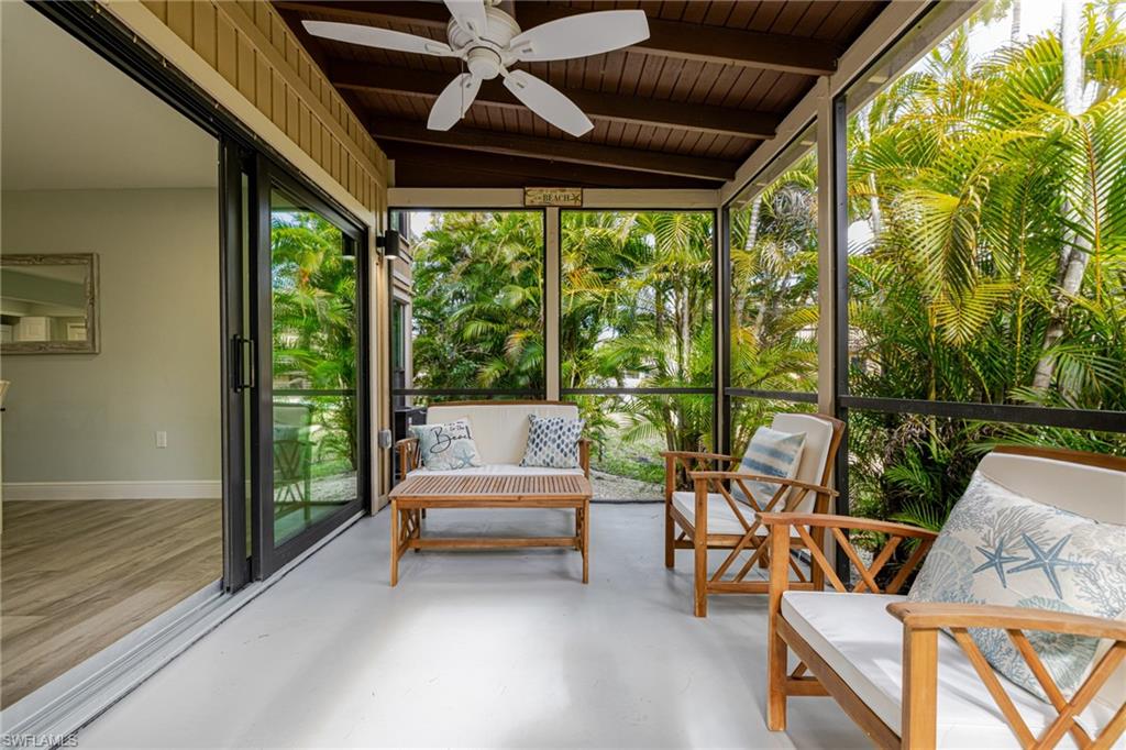 Sunroom / solarium featuring a ceiling fan and lofted ceiling with beams