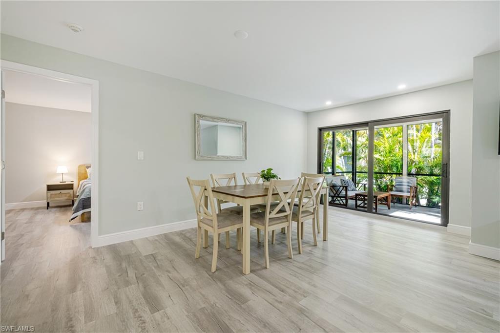 Dining space with light wood-style flooring and recessed lighting