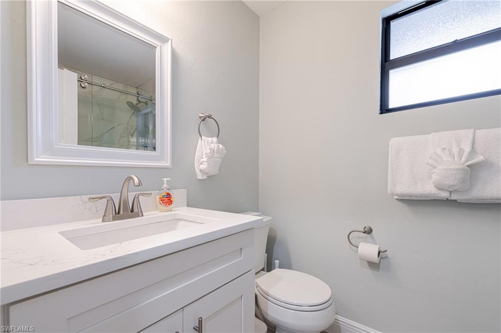 Bathroom with curtained shower and vanity