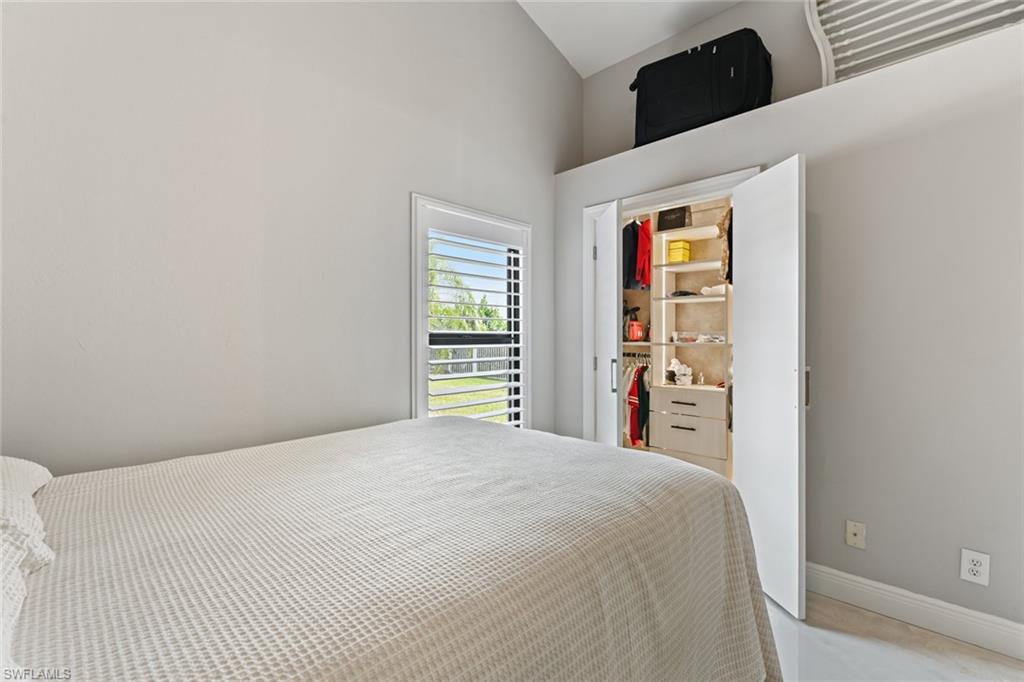 Bedroom featuring baseboards and vaulted ceiling