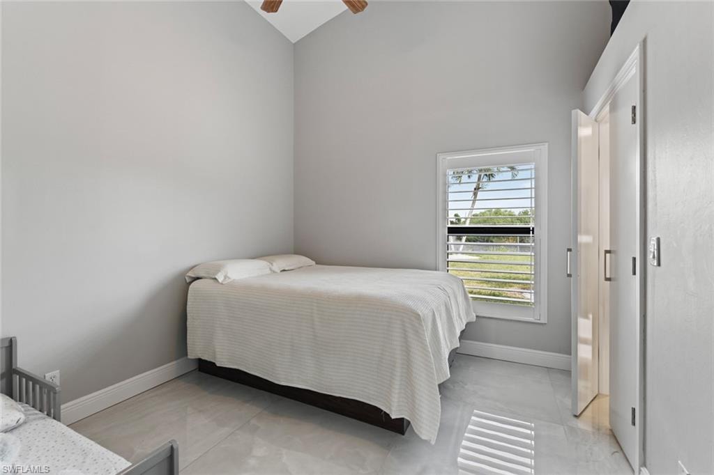 Bedroom with lofted ceiling and ceiling fan