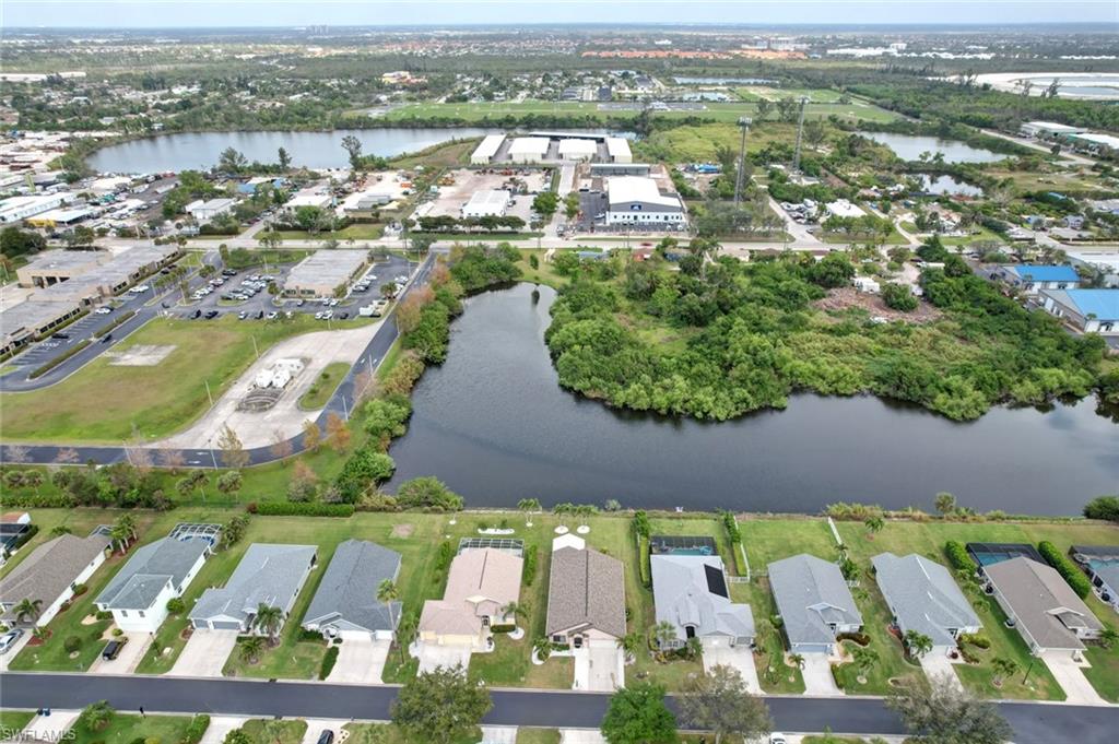 Aerial view of property's location with a large body of water and nearby suburban area