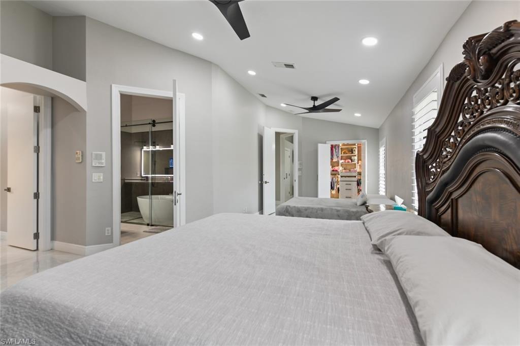 Bedroom with connected bathroom, recessed lighting, vaulted ceiling, and ceiling fan
