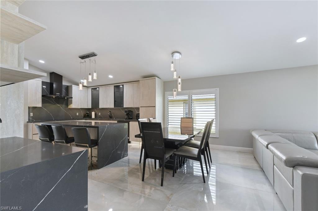 Dining space with baseboards and recessed lighting