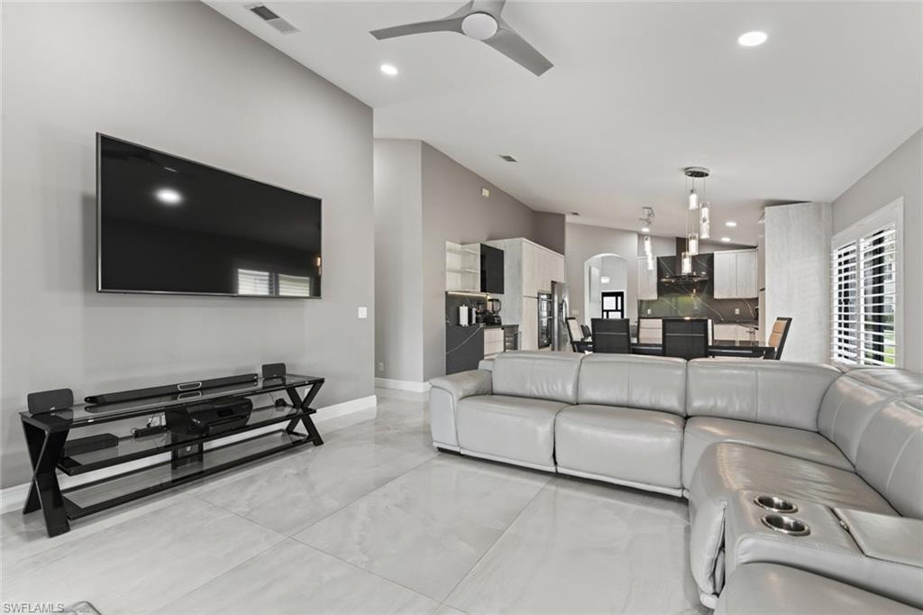 Living room with ceiling fan and recessed lighting