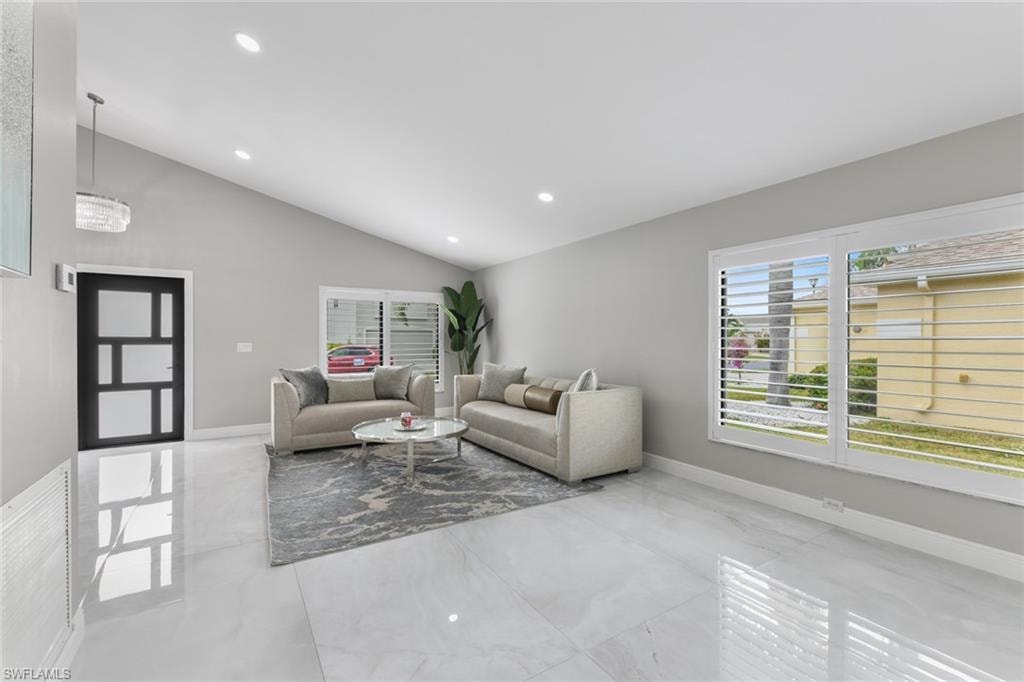 Living room with recessed lighting and vaulted ceiling