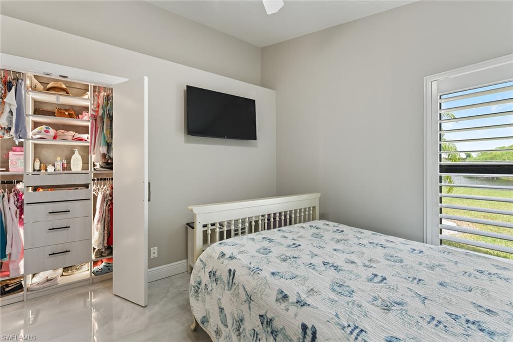 Bedroom with ceiling fan and a closet