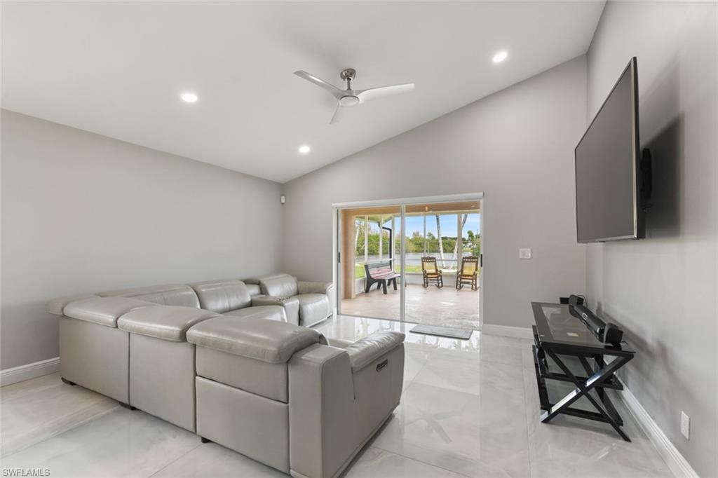 Living area with a ceiling fan, lofted ceiling, and recessed lighting