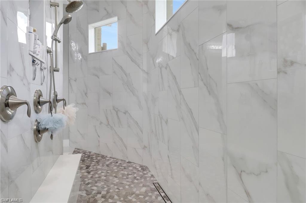 Full bath featuring tiled shower
