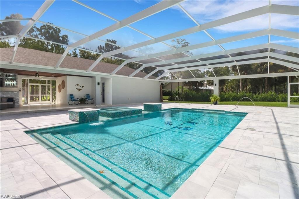 Integrated pool / hot tub with a lanai, a patio area, and a sunroom