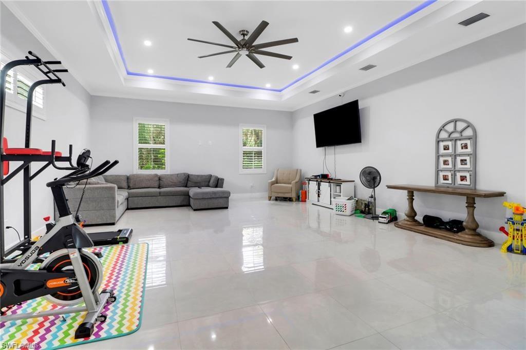 Workout room featuring ceiling fan, recessed lighting, and light tile patterned floors