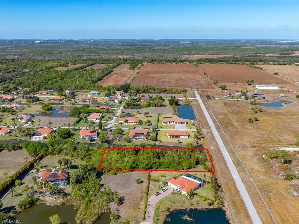 Overview of rural landscape with property boundaries highlighted and a large body of water