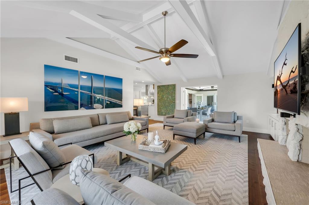 Living Room has volume ceiling with exposed beams