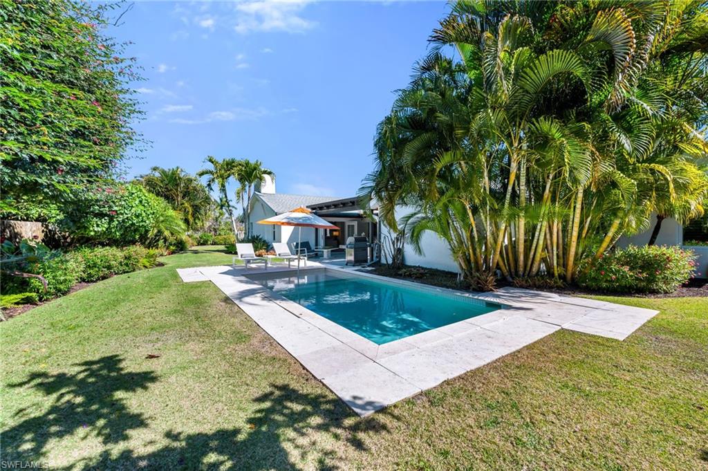 Open Pool area surrounded with lush landscaping