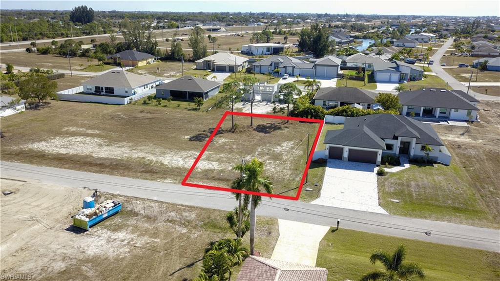 Aerial view of residential area with property boundaries highlighted