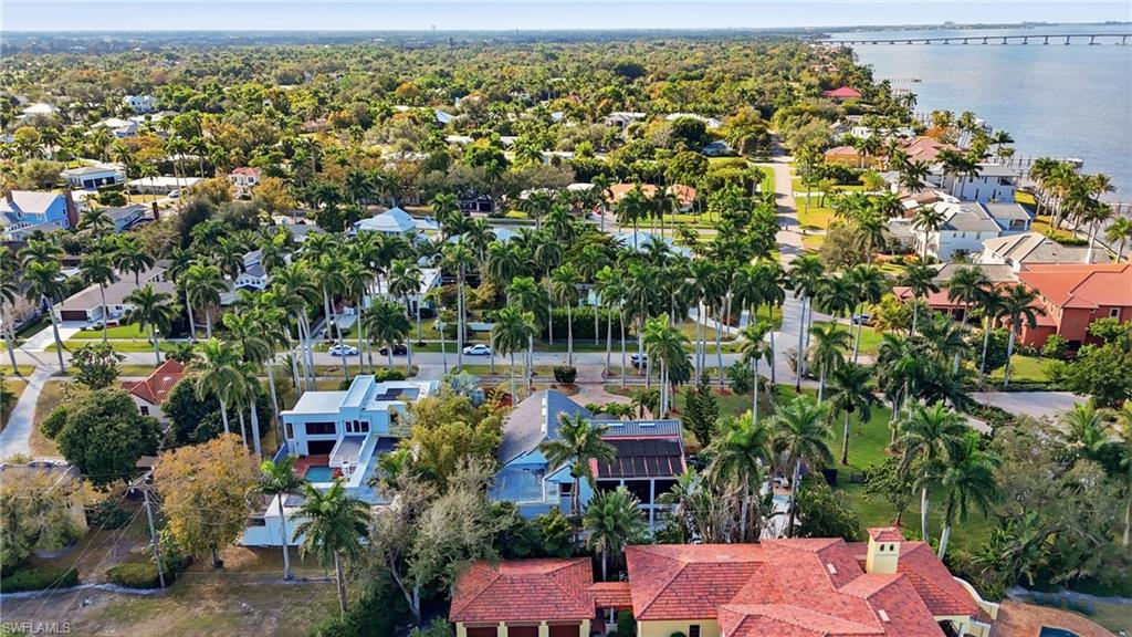 Aerial perspective of suburban area featuring a notable bridge and a nearby body of water