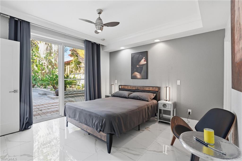 Bedroom with access to outside, ceiling fan, recessed lighting, and marble finish floors