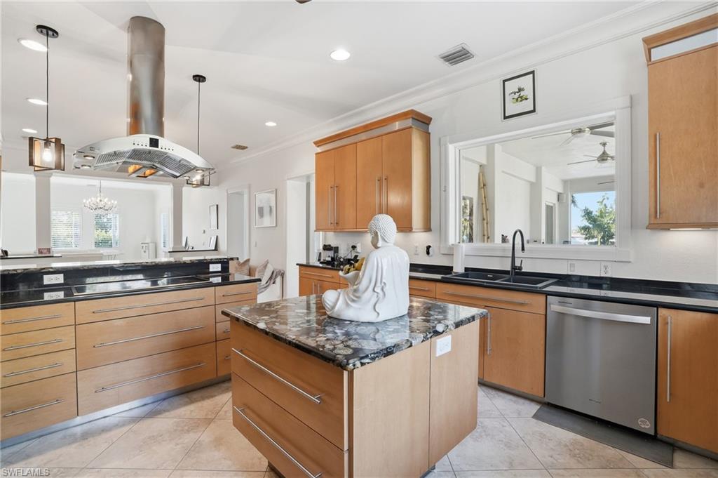 Kitchen featuring ornamental molding, ceiling fan, stainless steel appliances, a center island, and island exhaust hood