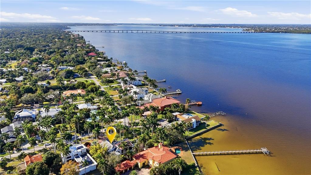 Aerial view of residential area featuring a notable bridge and a large body of water