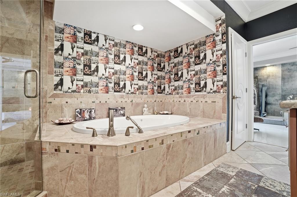 Full bath featuring a bath, a stall shower, and crown molding