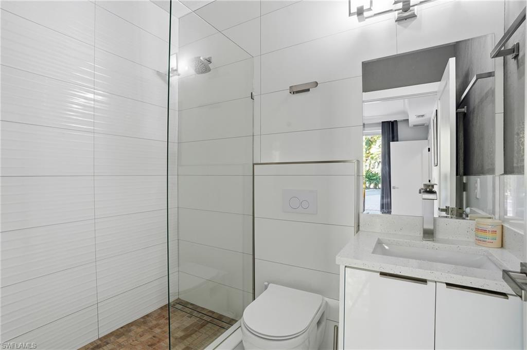Bathroom featuring walk in shower and vanity
