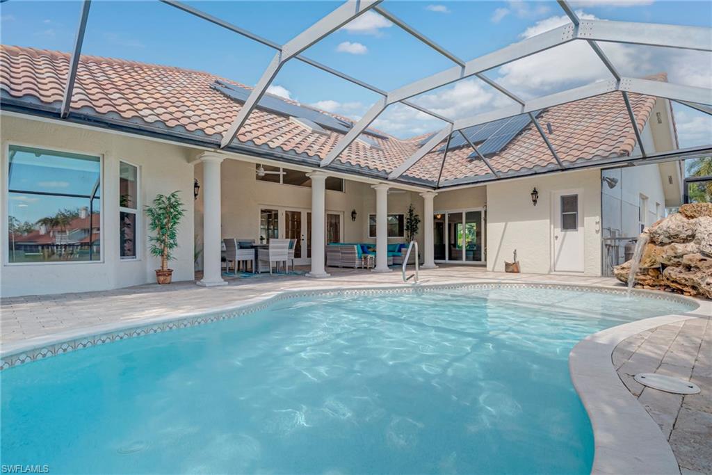 Swimming pool with a patio, an outdoor living / dining area, a lanai, and a sunroom