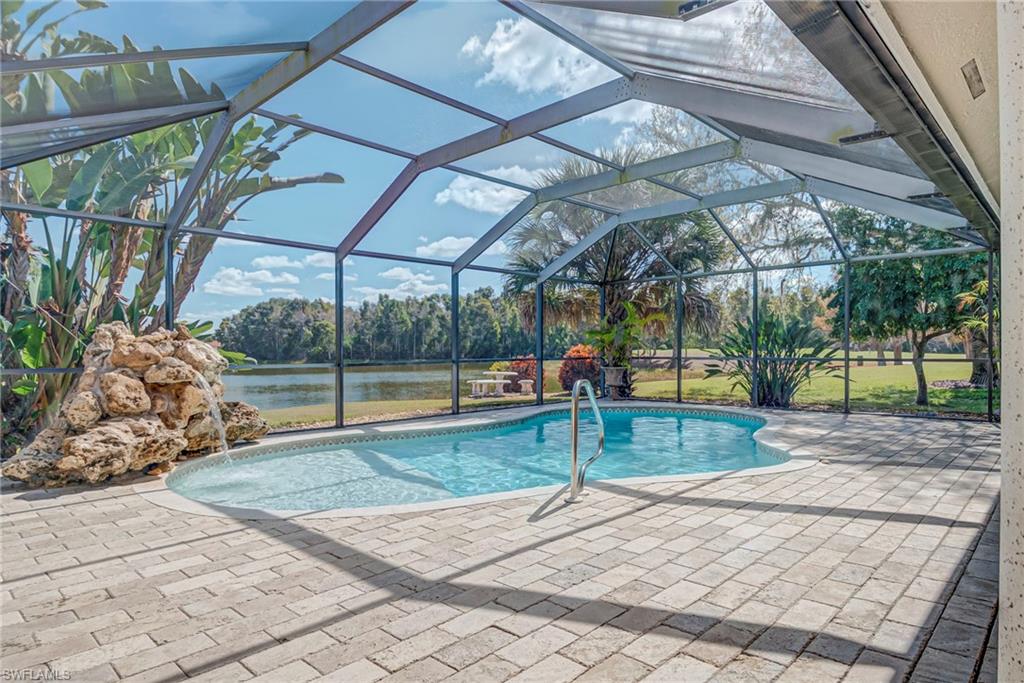 Outdoor pool with a lanai, a water view, a patio, and a sunroom