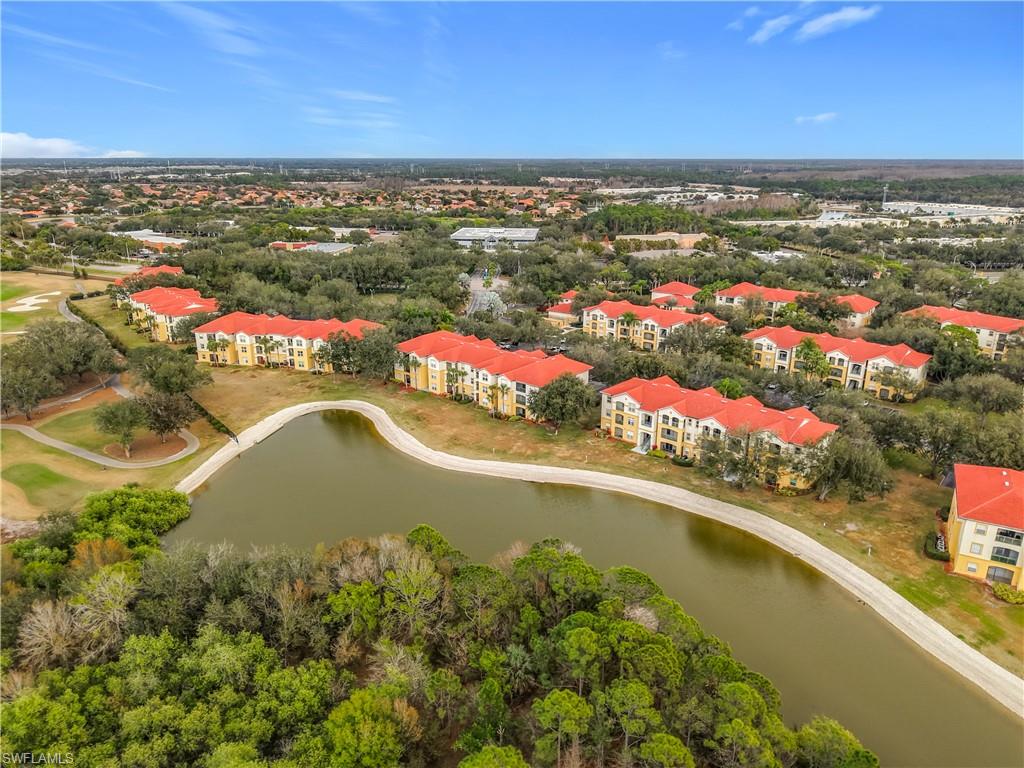 Drone / aerial view of a large body of water and apartment complex / building