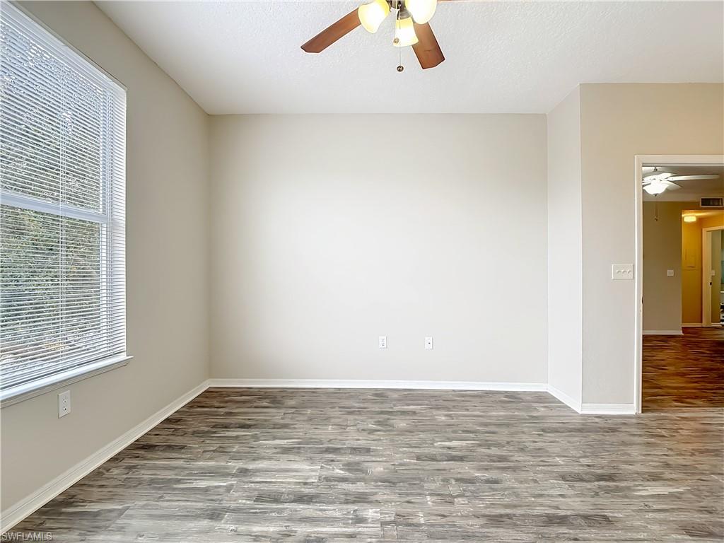 Spare room featuring ceiling fan, wood finished floors, and a textured ceiling